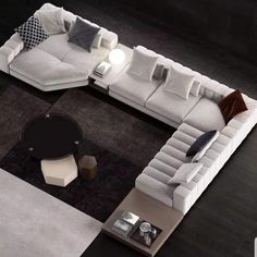 a white couch sitting on top of a black and white rug