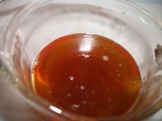 a glass bowl filled with liquid on top of a table