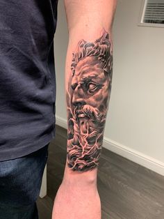 a man with a lion tattoo on his arm