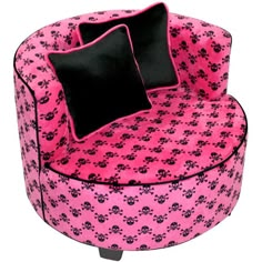 a pink chair with black pillows on it