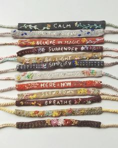 six bracelets with words written on them