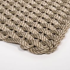 a close up view of a piece of rope on a white tablecloth that looks like woven fabric