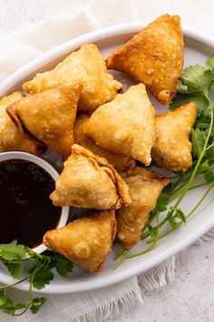 some fried food on a plate with dipping sauce