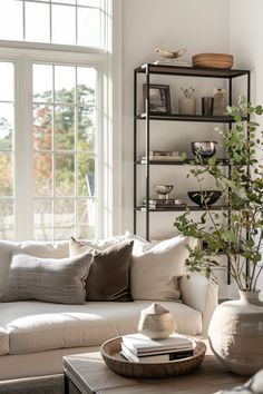 Bright and airy modern farmhouse living room featuring cozy seating, lush plants, and stylish storage solutions.