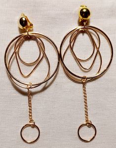 Unique and light light style These hang 4.5 inches Gold metal clip on Multi hoop style  These are very lightweight on the ear Easy to wear Statement style They are one of a kind These Earrings are a classic and timeless addition to any wardrobe Modern Small Hoop Metal Clip-on Earrings, Metal Small Hoop Clip-on Earrings, Modern Gold-tone Metal Clip-on Earrings, Gold Clip-on Earrings, Gold Circle Clip-on Earrings, Elegant Gold Circle Clip-on Earrings, Small Metal Clip-on Hoop Earrings, Gold-tone Drop Clip-on Earrings, Gold Clip-on Hoop Earrings For Party