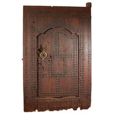 an old wooden door with metal rivets and a lock on the front, isolated against a white background