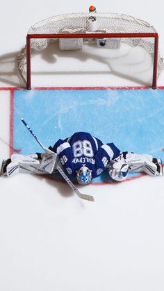 an ice hockey player laying on the ice