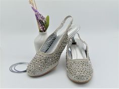 Our new collection of designer wedding shoes which we offer for you, these cute shoes are silver embroidered with silver beads and crystals in a lovely even design that stand out to give it a beautiful complete look also to add the shine is a 2 rows of rhinestones so they are simple as well as elegant looking shoes. with the elastic on the back it fits comfortable so you can wear them for long hours . These have a low heel of 2inches in silver and rubber tip. Don't miss out on these beauties the Silver Heels With Rhinestones For Reception, Summer Wedding Shoes Silver Embellished, Silver Open Toe Heels For Reception, Silver Wedding Shoes With Rhinestones For Reception, Silver Rhinestone Wedding Shoes For Reception, Silver Glamorous Heels For Reception, Glamorous Silver Heels For Reception, Open Toe Wedding Shoes With Rhinestones For Reception, Crystal Embellished Open Toe Wedding Shoes For Reception