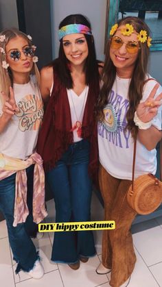 three girls in hippie costumes posing for the camera with one holding up her peace sign