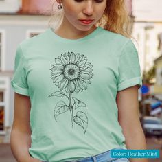 Sunflower, Sunflower Shirt, Floral Tee Shirt, Womens Spring Shirt, Flower Shirt, Garden Shirt, Sunflower Tshirt, Sunflower Shirts, Sunflower Tee  Super soft sunflower heather sport-blend T-shirt. We love our sunflower days This super soft spring and summertime tee is perfect for gift giving or for yourself. We think you'll enjoy our This sunflower shirt might just become your favorite! Our Heather sport-blend is what makes our sunflower T-shirts so comfortable, and gives them that vintage-style look. We use a 52% cotton and 48% polyester blend in all our heather-sport colors and 100% Airlume combed, ring spun cotton in our solid colors. (See our other listing for our solid-colored Teacher tees.)  WANT 20% OFF YOUR ORDER? SIGN UP FOR OUR NEWSLETTER TO RECEIVE 20% OFF YOUR NEXT ORDER: https: Sunflower Tshirt, Garden Shirt, Soft Spring, Sunflower Shirt, Gardening Shirts, Floral Tee, Teacher Tees, Sunflower Design, Flower Shirt