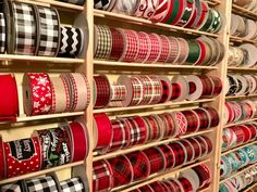 the shelves are filled with many different types of christmas ribbons and ribbon holders on them