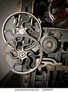 an old clock mechanism with gears and dials on it's side, in the dark