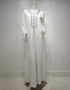 SPECIFICATIONS Elevate your style with our Polyester Abaya adorned with intricate embroidery. Perfect for various occasions, this piece combines comfort and sophistication effortlessly. Order now to embrace a timeless and fashionable look. Processing Time : 20-25 Business Days Department Name: Adult. Material: High-quality Polyester for comfort and durability. Decoration: Exquisite Embroidery, adding a touch of elegance. Item Type: Abaya, a versatile and stylish addition to your wardrobe. Elegant Long Sleeve Thobe With Dabka Embroidery, Elegant Long Sleeve Thobe With Dabka, White Embellished Long Dresses, Elegant Long Sleeve Abaya With Dabka, Elegant Long-sleeved Dabka Abaya, Embellished Long Sleeve Thobe For Eid, Elegant Dabka Thobe For Eid, Elegant Embroidered Floor-length Abaya, Elegant White Long Sleeve Agbada