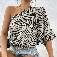 Zebra Pattern One Shoulder Blouse, Elegant Loose Fit Top For Spring & Summer, Women's Clothing Boutique Sizes Available In Lettering: Xs (2) S (4) M (6) L (8/10) Xl (12) Xxl (14) !!*Please Note*!! *This Is A Pre-Order Item And Requires A Longer Shipping Time. Please Allow 7-14 Business Days Before Shipping.* Thank You For Your Patience. Once Ordered Is Placed We Will Notify You Of An Expected Shipping Date. Bundle 2 Or More Items From My Closet For A 15% Discount. Tags: Spring Summer Fall Winter Chic Beige Printed Tops, Batwing Sleeve Blouse, Half Sleeve Blouse, Loose Fitting Tops, Short Sleeve Pullover, Pullover Shirt, Summer Fashion Outfits, Women Clothing Boutique, Off Shoulder Tops