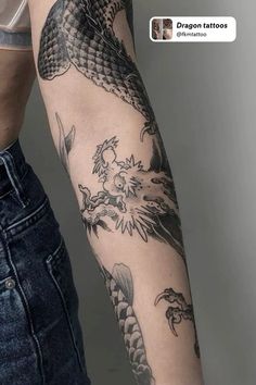 a woman's arm with tattoos on it and an image of a dragon tattoo