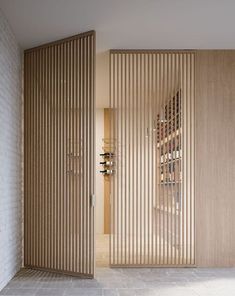 the wine rack in the room is made out of wood and has vertical slats