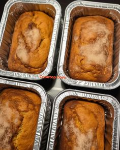 four pans filled with baked goods sitting on top of a table