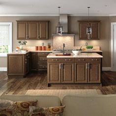 a large kitchen with wooden cabinets and white counter tops in a living room or dining room