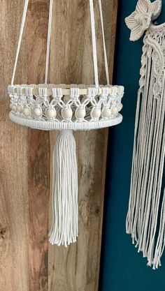 a white macrame hanging from a wooden wall