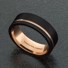 a black and gold wedding band with the words, tunsten caribee on it