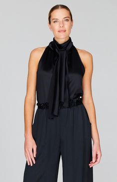 An elegant tie neck blouse cut in luxurious silk satin. The full ties can be worn loose down the back or draped around the neck and the elegant halter neckline is perfect worn alone or under a jacket. Elegant Tie-back Halter Top For Night Out, Elegant Sleeveless Tie Back Blouse, Elegant Sleeveless Tie-back Blouse, Elegant Satin Halter Neck Top, Chic Tie-back Blouse For Parties, Elegant Tie Back Halter Top For Evening, Elegant Silk Tie Neck Top, Elegant Evening Halter Top With Tie Back, Satin Tie Back Halter Top For Evening