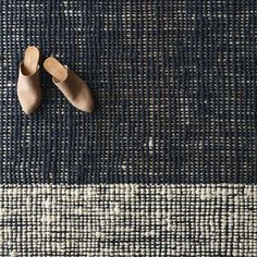 a pair of shoes sitting on top of a rug