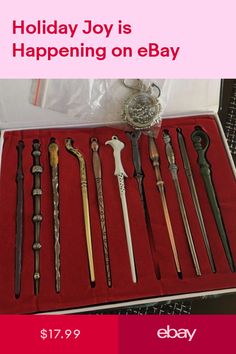 an assortment of different types of knives in a display case on a red tablecloth