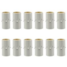 eight white vases with gold rims are lined up in a row on a white background