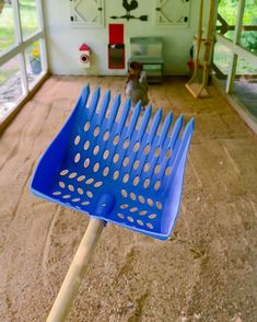 a large blue brush sitting in the middle of a room