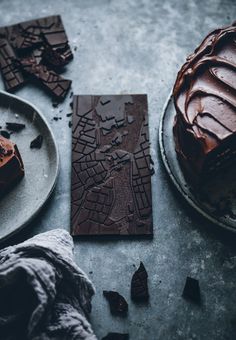 a piece of chocolate cake sitting on top of a plate next to a knife and fork