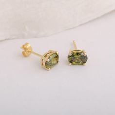 Elevate your accessory collection with our exquisite 14K Solid Gold Oval Stud Earrings featuring the stunning August birthstone, Peridot. Crafted from high-quality, sustainable materials, these earrings are designed to offer a luxurious touch while being gentle on sensitive ears.The vibrant green hues of the Peridot are known to symbolize strength and growth, making these earrings not just a beautiful adornment but also a meaningful gift for those born in August. Handcrafted with love and precis Oval Peridot Earrings For Gift, Oval Stud Earrings, Peridot Earrings, Peridot Necklace, August Birthstone, Green Hues, August Birth Stone, Chic Accessories, Vibrant Green