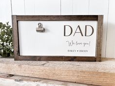 a father's day sign on a shelf with a keychain attached to it