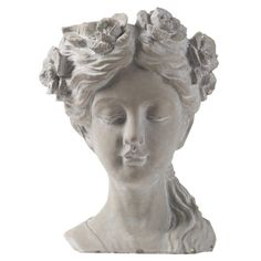 a white statue with flowers in her hair