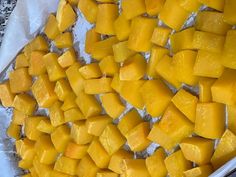 a tray filled with cut up pieces of mango