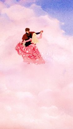 a man and woman are flying through the clouds