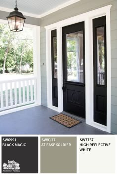 the front door of a house with two black doors and a brown mat on the floor