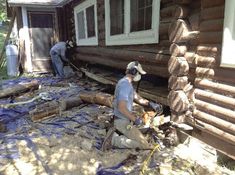 two men working on the side of a house