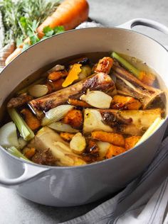 a pot filled with meat and vegetables on top of a table