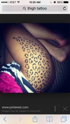 a woman's leg with a tattoo on it that has an animal print pattern