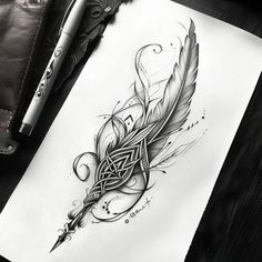 a drawing of a feather with an intricate design on the back of its head, next to a pen and paper