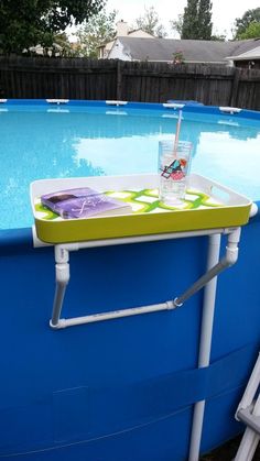 a pool table with a drink on it in the middle of an empty swimming pool