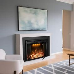 a living room filled with furniture and a fire place next to a painting on the wall