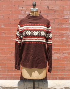 This is a brown crew neck sweater with red/orange and white detailed pattern across the front and its 100% acrylic Measurements (taken flat): Bust: 44" Waist: 44" Sleeve: 20.5" Shoulder: 16" Length: 27" Condition: Excellent Vintage Condition *Please keep in mind our items are previously loved vintage goods and may have some small flaws. We do our best to make shoppers aware of any spots, stains, or tears. Measurements are taken flat and in inches. Please remember that vintage tag sizes are often unreliable and it is best to judge sizes by the measurements provided. All sales are final. Sorry, no returns or exchanges. Please message us if you have any questions about an item, we'd love to help! FREE Shipping within the continental United States! We ship every Monday. If you need your item(s Mens Pullover, Pullover Sweater Men, Pullover Men, Chicago Il, Vintage Brown, Vintage Tags, Crew Neck Sweater, Neck Sweater, Sweater Outfits