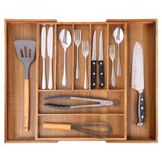 a wooden tray with utensils and spoons in it