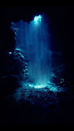 an underwater cave with sunlight streaming through the water