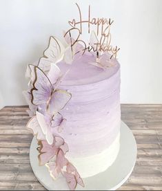 a purple and white cake with butterflies on it