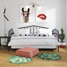 a bedroom with white walls, wooden floors and pictures on the wall above the bed