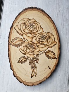 a wooden plaque with roses on it