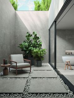 an outdoor bathroom with a chair, tub and potted plant in the corner next to it