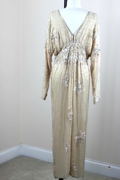 "I absolutely love this dress, I have seen some different colors and similar style and I absolutely love it. It is so 1930s. There are amazing sequin beaded designs on it and silver beads and sequins throughout. An absolutely beautiful gown!! This is in Very good to Excellent condition!! A true beauty!! Measuring; 56\" length Bust: 40\" (this is blouson, it is actually a bit larger as it is a blouson style Waist: 26\" Hip\" 40\" Sleeves: 25\" This definately is not a stretchy style dress, it is Beaded Wedding Dress Vintage, Sequins Gown, Beaded Wedding Dress, Wedding Dress Vintage, Beaded Party Dress, Beaded Jacket, Wedding Dresses Beaded, Etsy Wedding Dress, Beaded Wedding